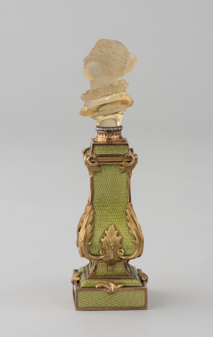 Perfume bottle with a cap in the shape of a woman's head